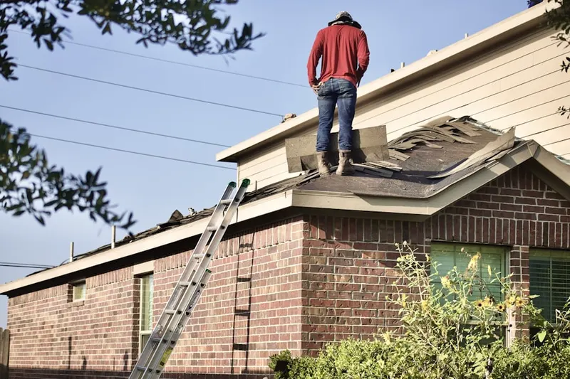 Professional roofer working on a residential roof in Gainesville
